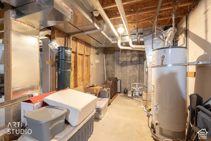 Exposed ductwork, water heater, and unfinished walls