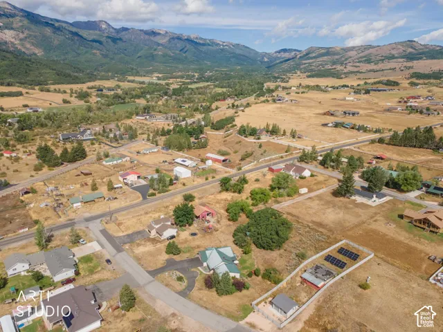 Expansive property featuring a solar array, fenced perimeter, and several outbuildings