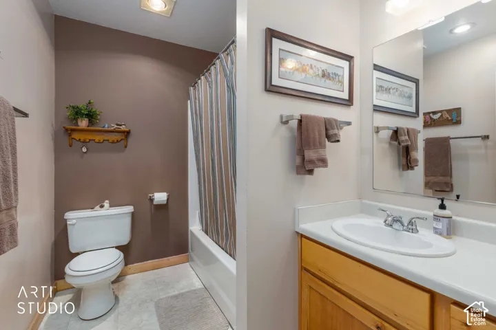 Bathroom featuring a vanity with wood cabinetry, a white countertop, and an integrated sink