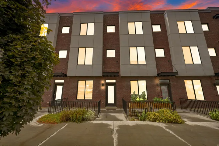 Multi-story exterior with brick and panel cladding