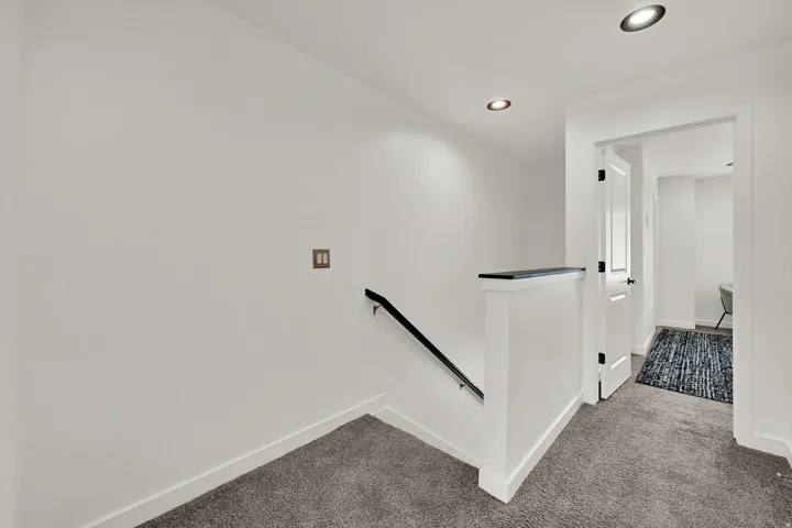 Recessed ceiling lighting, white interior doors, and carpeted flooring