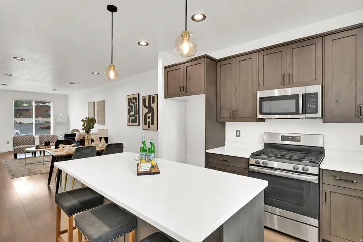 Modern kitchen featuring a gas range, stainless steel microwave, and wood-finish cabinetry