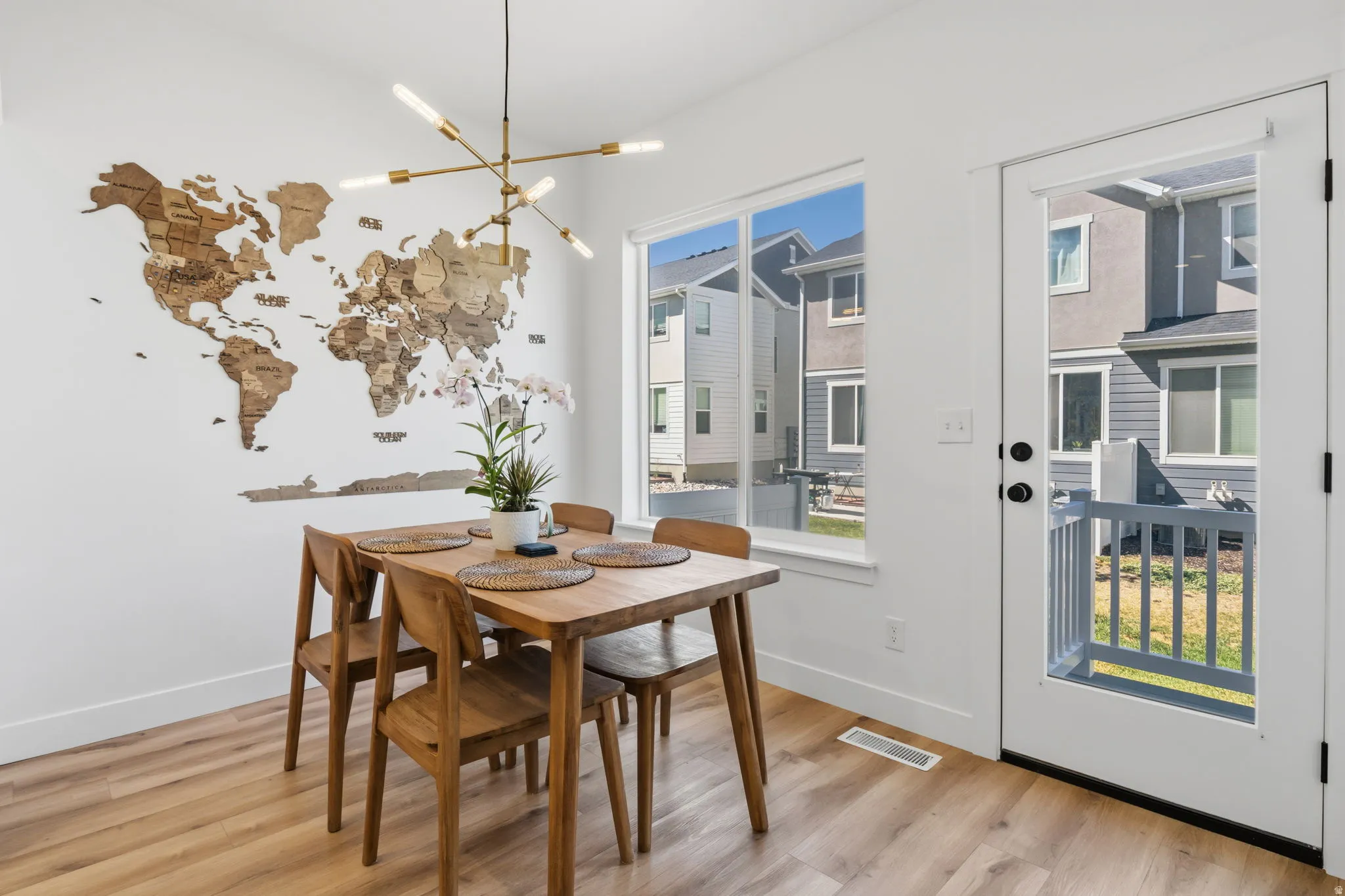 Wood-finish flooring throughout, large window, and glass-paneled door