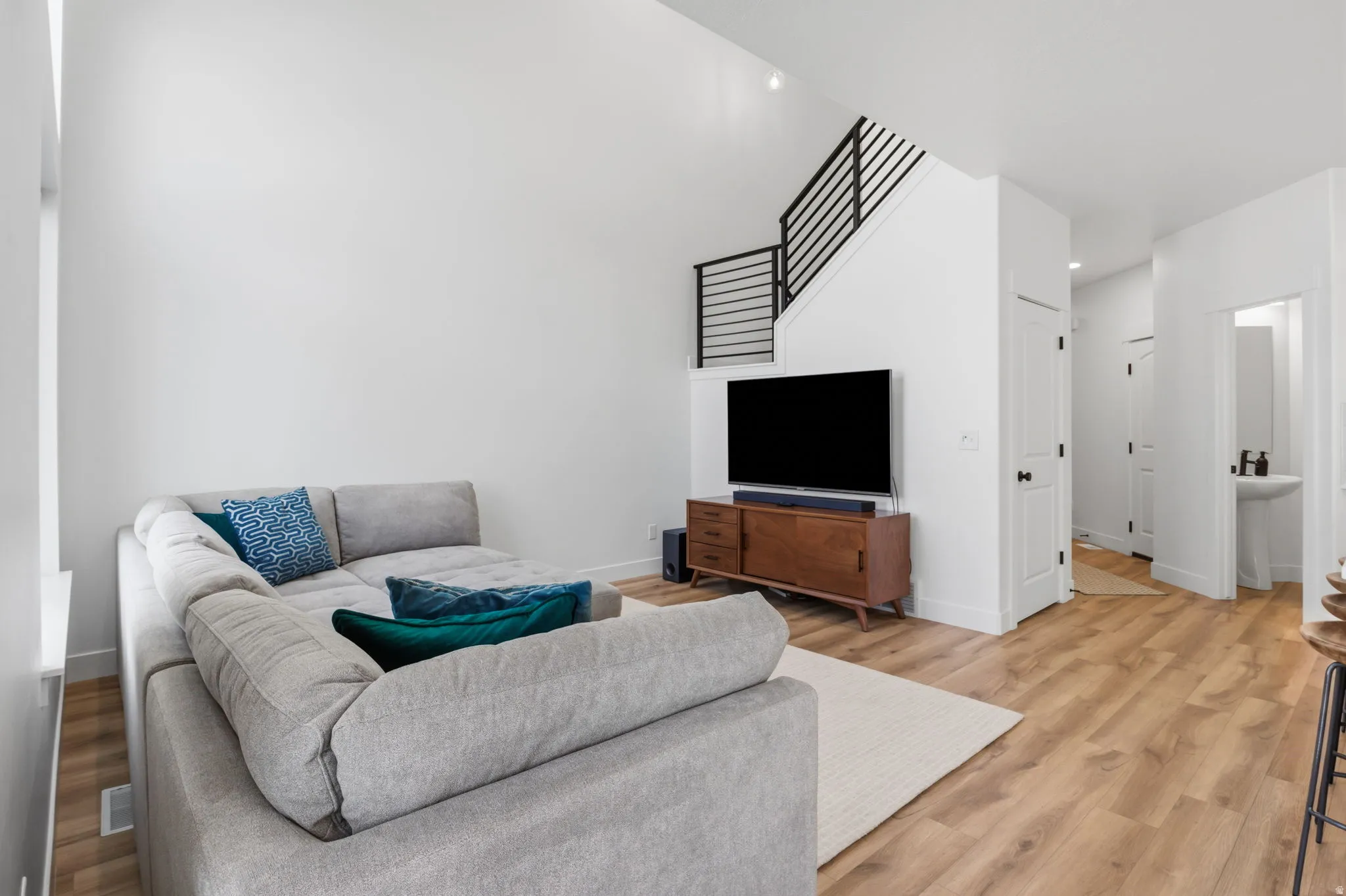 Open-concept living space with high ceilings and wood-finish flooring