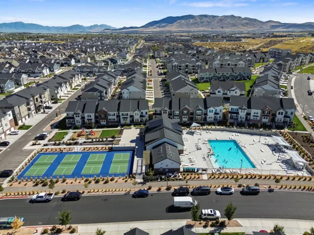 Community features a swimming pool, multiple tennis courts, a playground, and mountain scenery