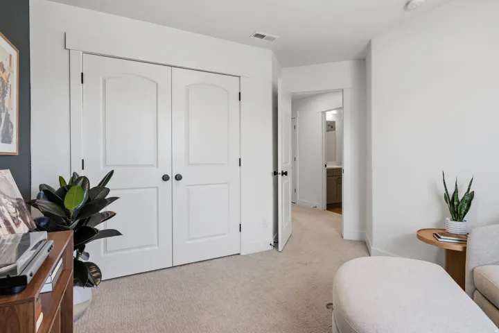 Neutral tone carpeting and white trim throughout