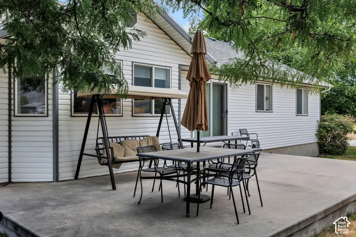 Expansive concrete patio with direct access to the interior through a sliding glass door.