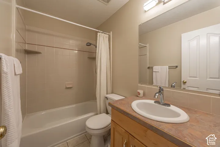 Bathroom featuring a vanity with a drop-in sink, chrome faucet, and wall-mounted mirror