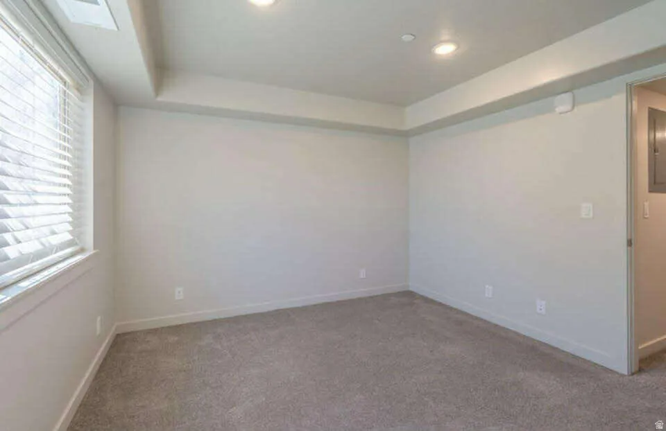 Recessed lighting, carpet flooring, window with blinds, and white trim