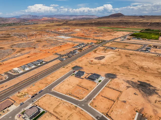 New construction residential development featuring paved streets, established homes, and undeveloped lots
