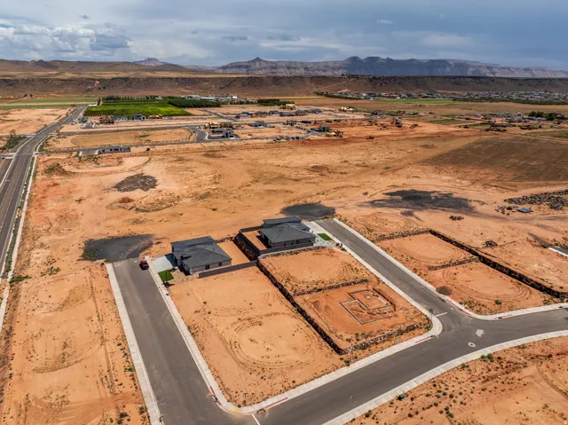 New construction development featuring established roadways and foundational groundwork