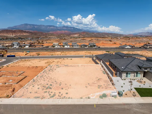 Expansive undeveloped lot with street frontage, mountain scenery, and proximity to paved roadways