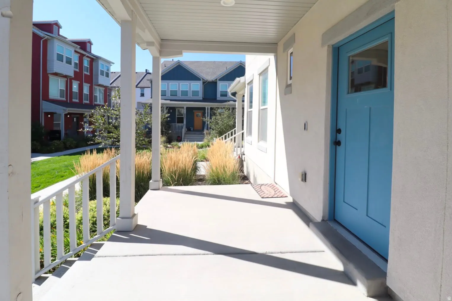 Covered front porch with white railings