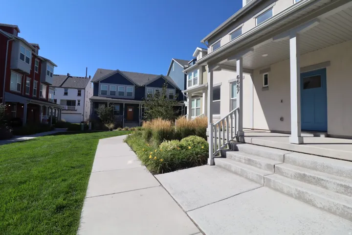 Covered front porch with light-colored siding