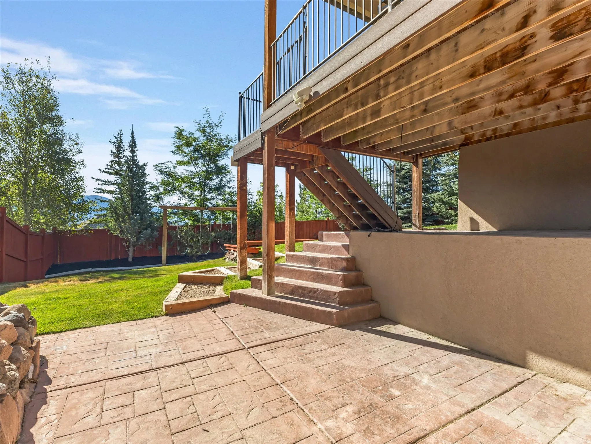 Expansive stamped concrete patio with direct access to a grassy yard