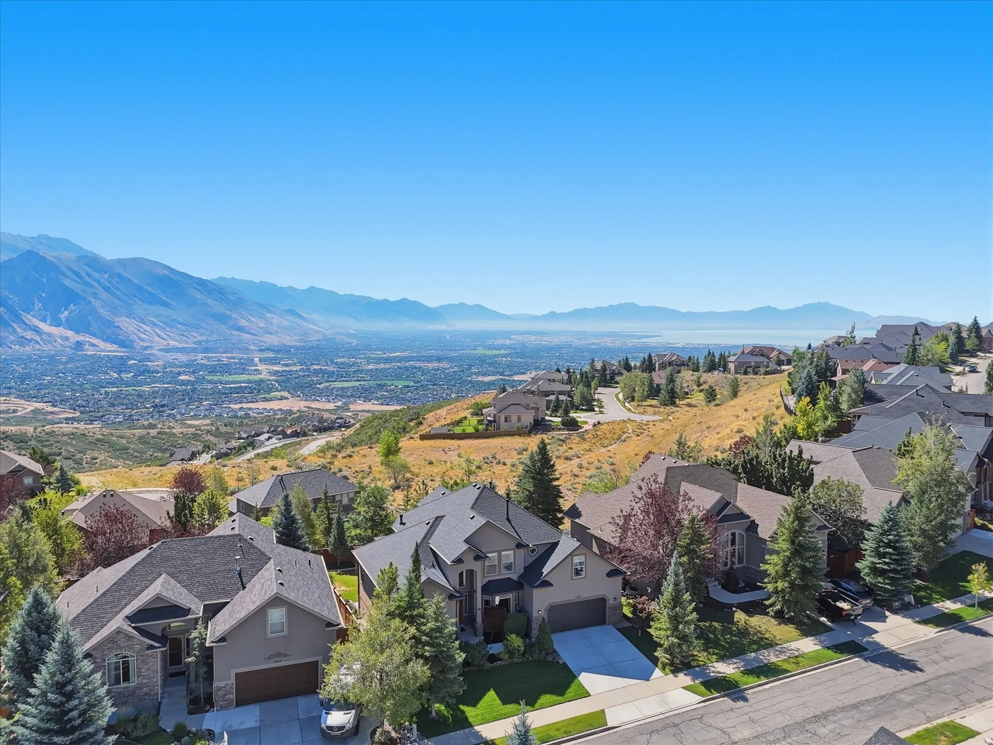 Mountain backdrop with a city and body of water in the distance