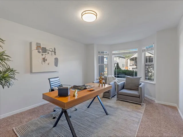 Bay window with multiple panes, neutral wall color, recessed lighting, and carpeted flooring