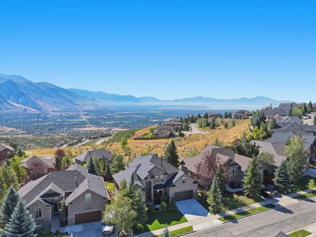 Mountain backdrop with a city and body of water in the distance