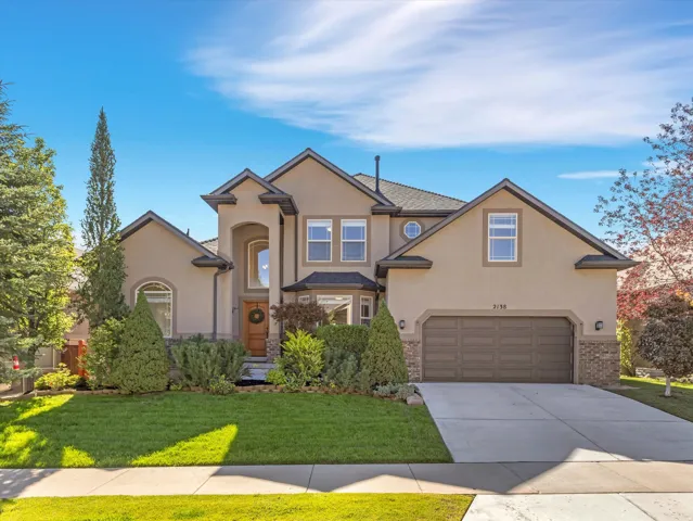 Stucco exterior with stone accents and a covered entryway