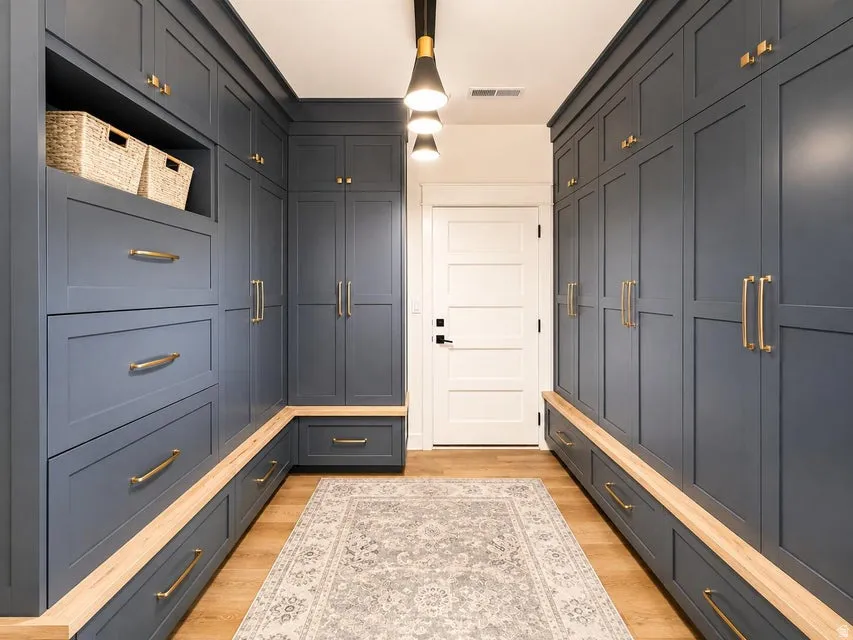 Built-in cabinetry with gold-finish hardware, integrated drawer storage, and light wood-finish accents
