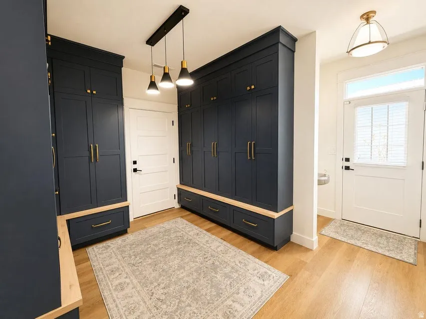 Built-in cabinetry with dark paneling and brass hardware, featuring wood-finish tops and integrated drawers