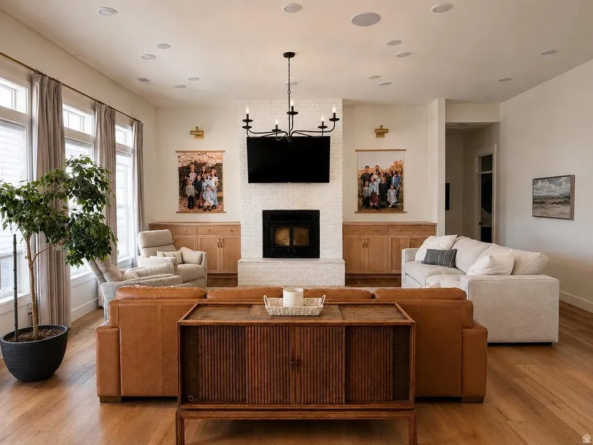 Living area with wood-finish flooring and multiple recessed ceiling lights