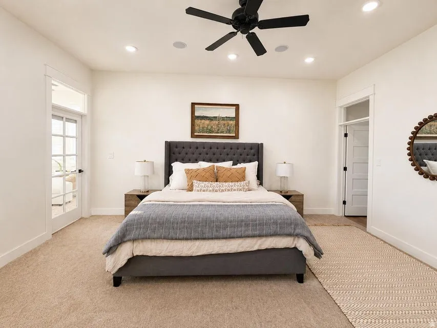 Plush carpet flooring, recessed ceiling lighting, a black ceiling fan, and French doors with transom windows