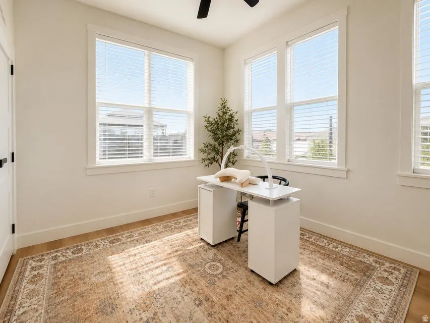 Wood-finish flooring with crisp white baseboards
