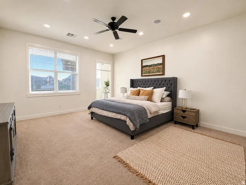 Recessed lighting, ceiling fan, expansive window, carpeted flooring, and balcony access