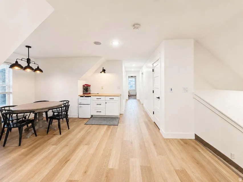 Wood-finish flooring throughout, complemented by crisp white walls and white trim