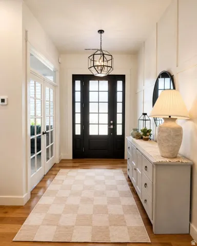 Hardwood-finish flooring with a modern geometric chandelier