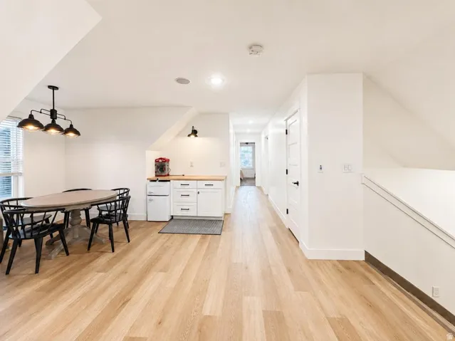 Wood-finish flooring throughout, complemented by crisp white walls and white trim