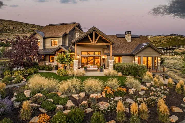 Exterior featuring horizontal siding, stone accents, and a shingled roof