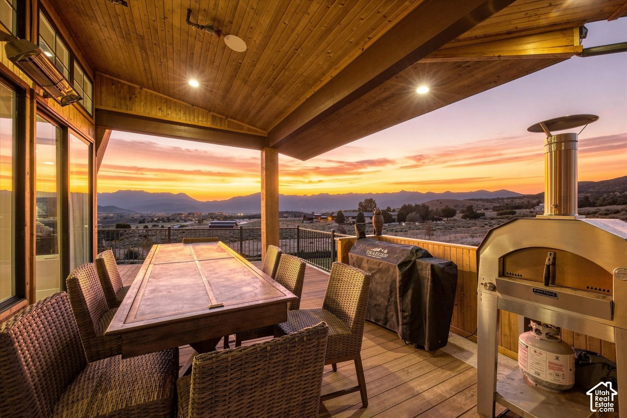 Covered deck with a wood plank ceiling and recessed lighting