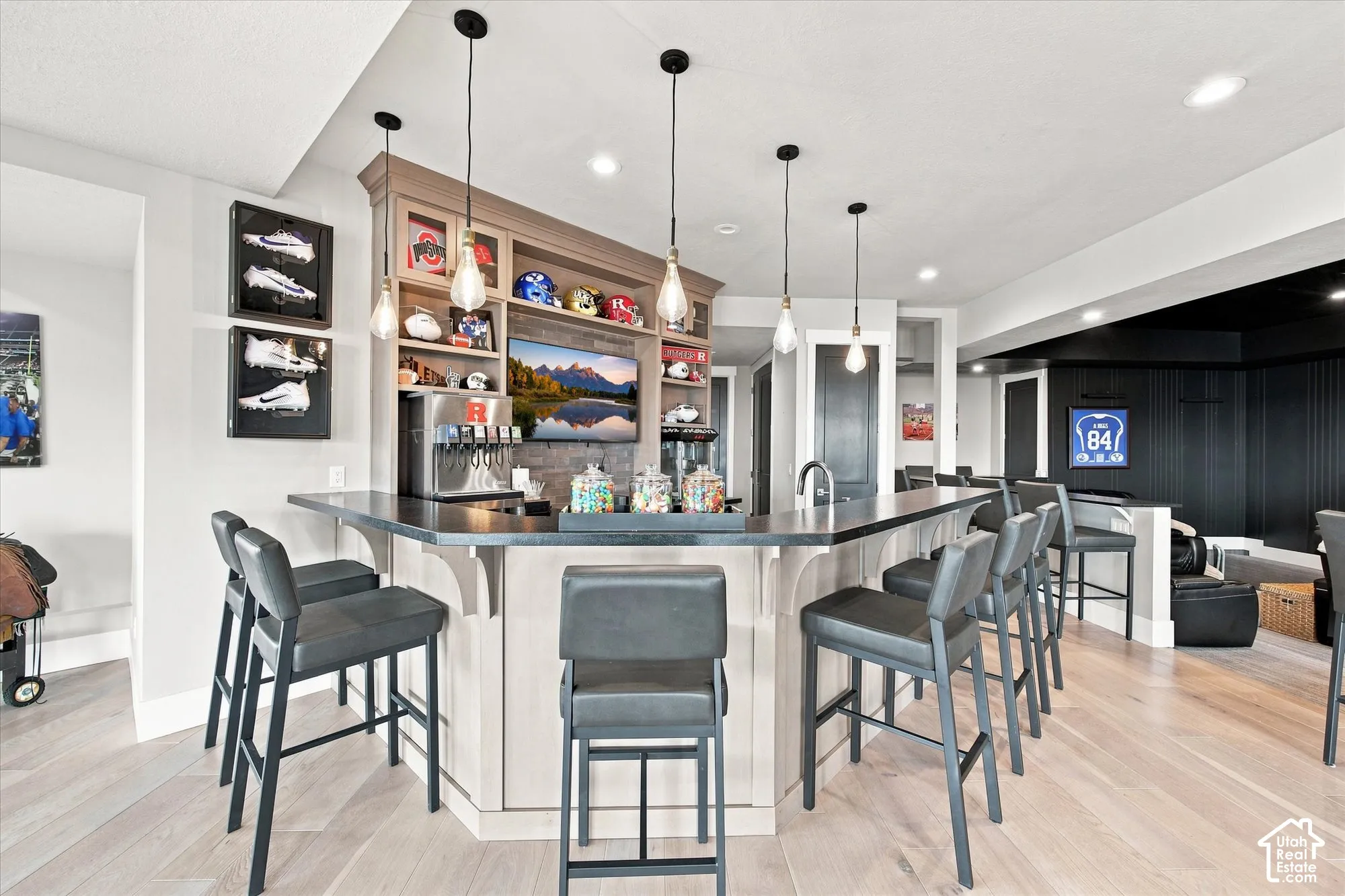 Built-in Full Outfitted Wet Bar with dark countertop, integrated sink, and display shelving