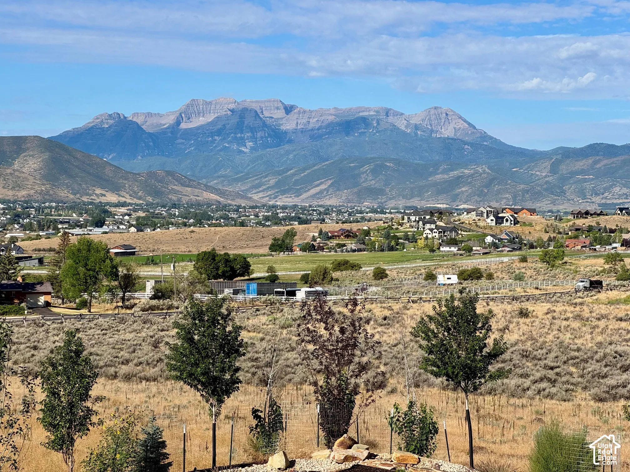 Primary Suite. Expansive mountain range backdrop with distant residential areas