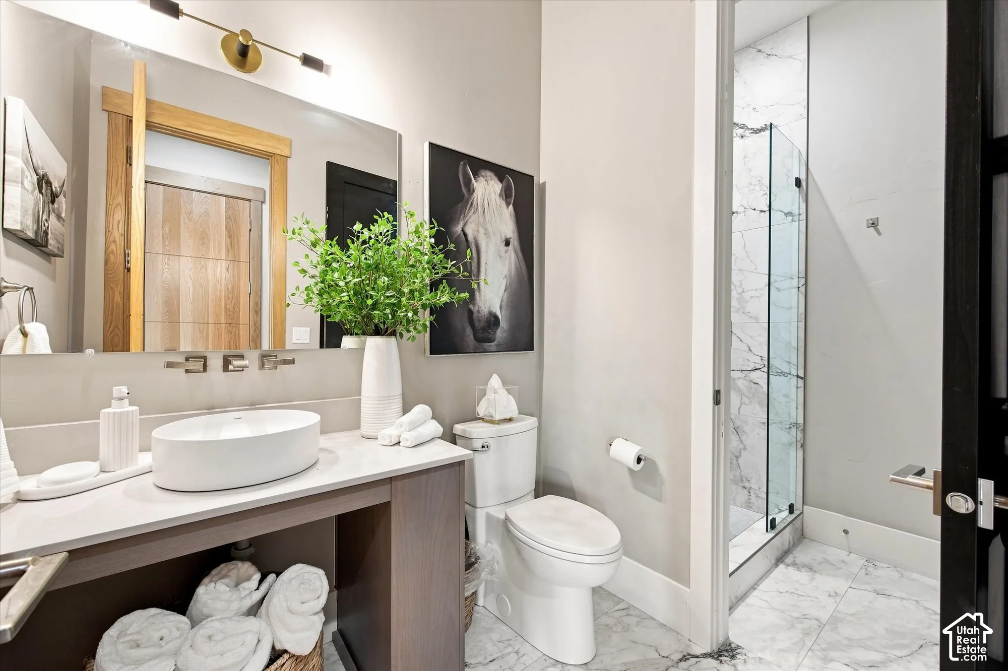 Office En-suite bathroom. Vanity with vessel sink, wall-mounted faucet, and integrated lighting