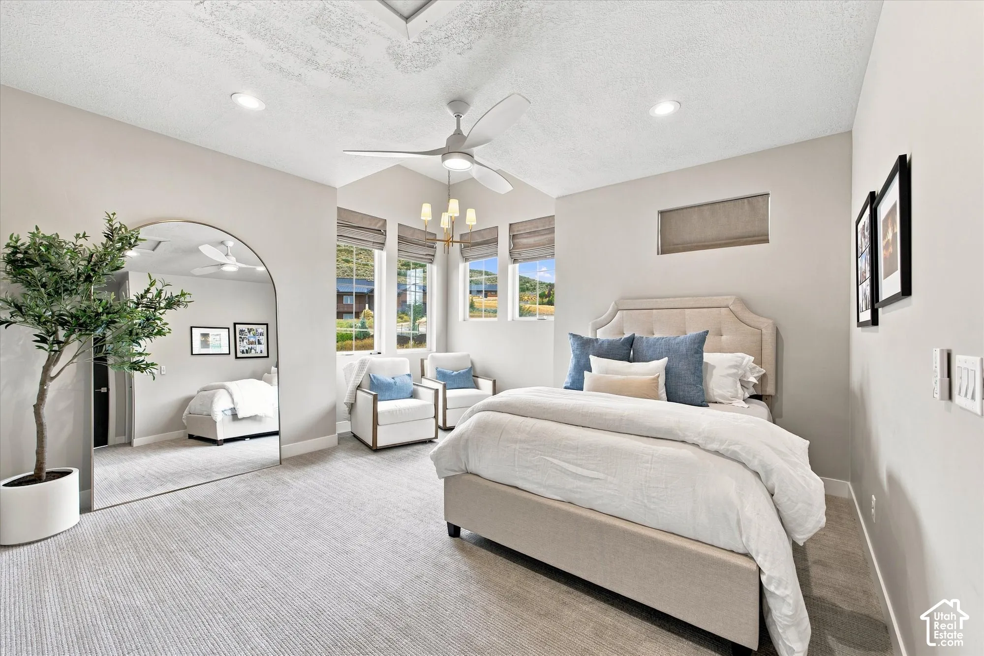 Vaulted ceiling with recessed lighting, integrated ceiling fan, multiple windows with blinds, and light-toned wall finishes