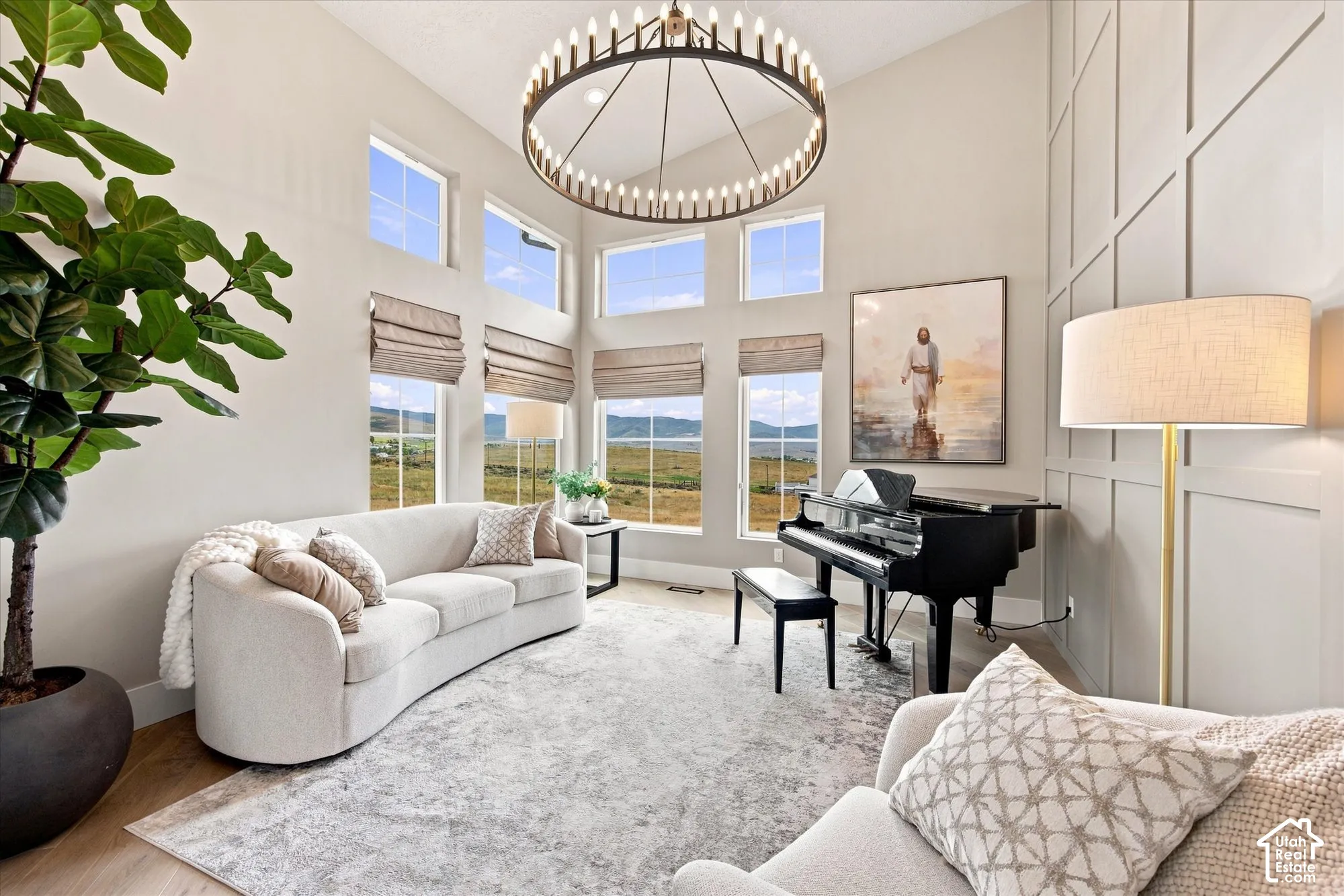 Two-story ceiling, a grid accent wall, and wood-finish flooring, Music room