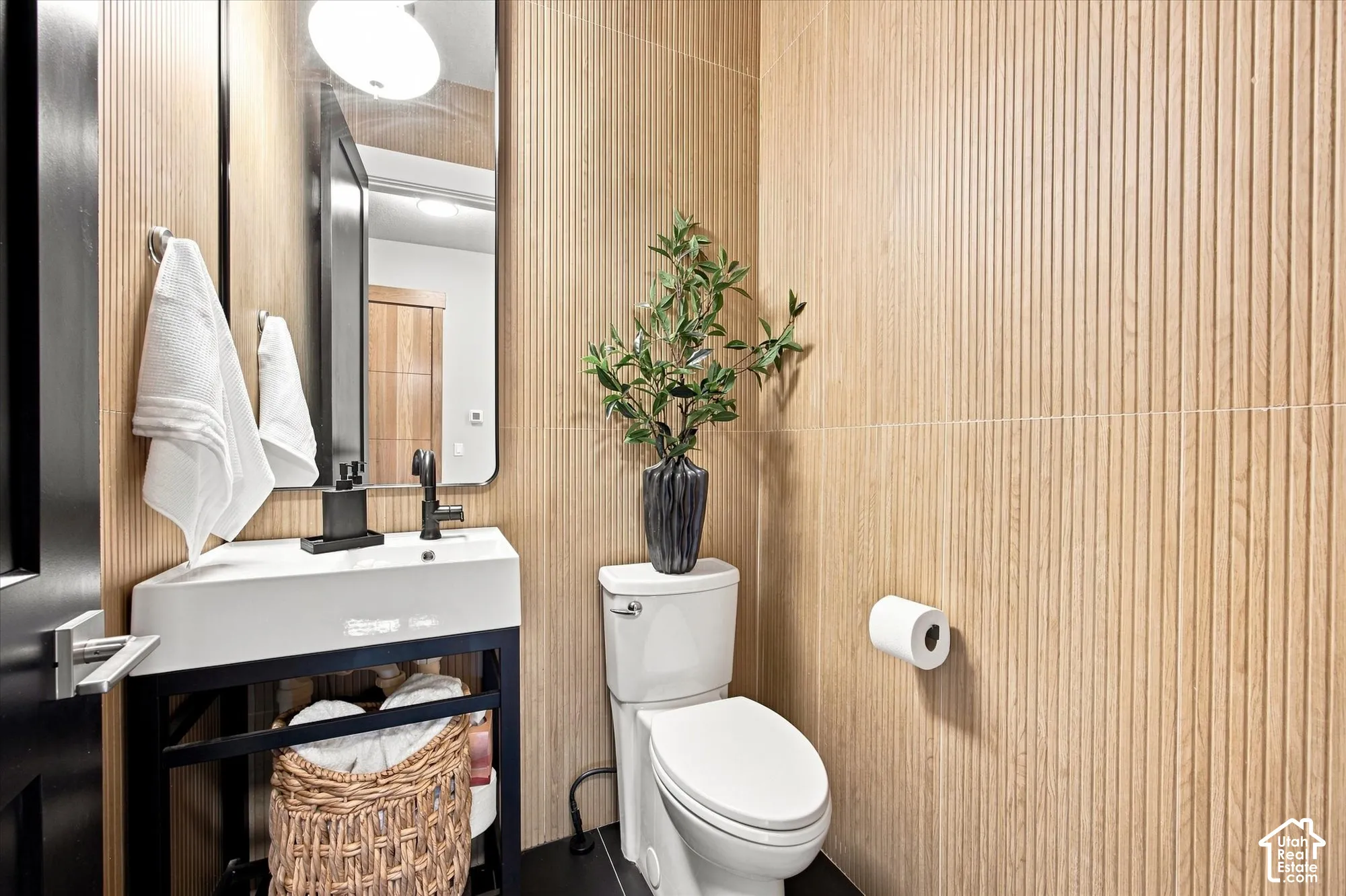 Powderroom with Modern vanity with a rectangular sink, wall-mounted faucet, and black framing
