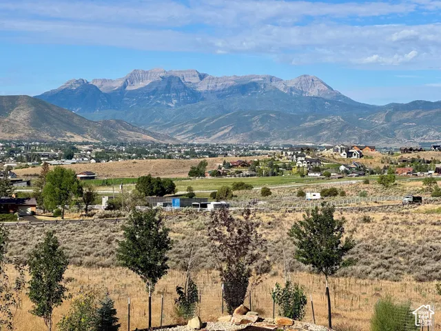 Primary Suite. Expansive mountain range backdrop with distant residential areas