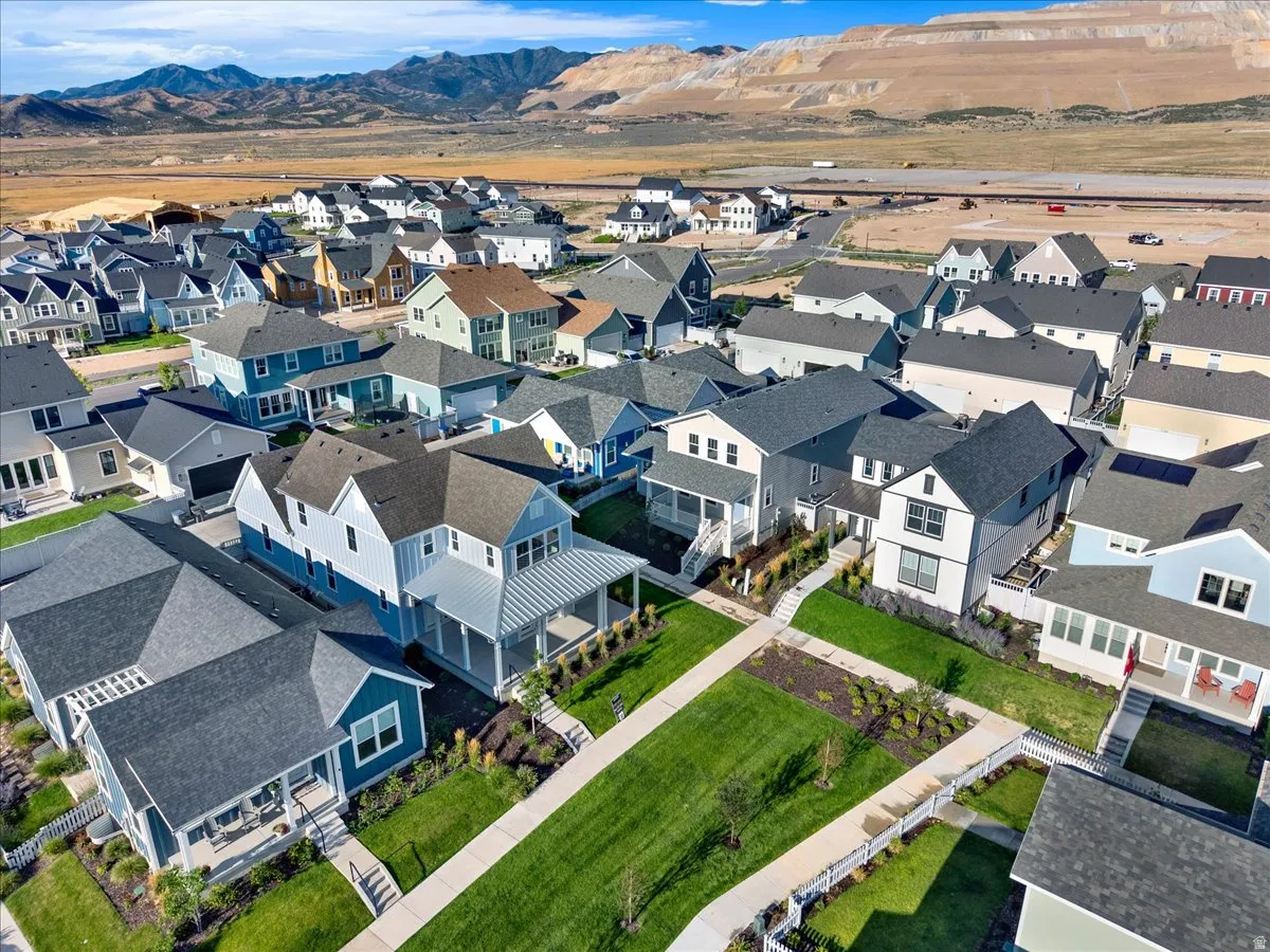 Community featuring diverse home exteriors, integrated green spaces, and mountain scenery