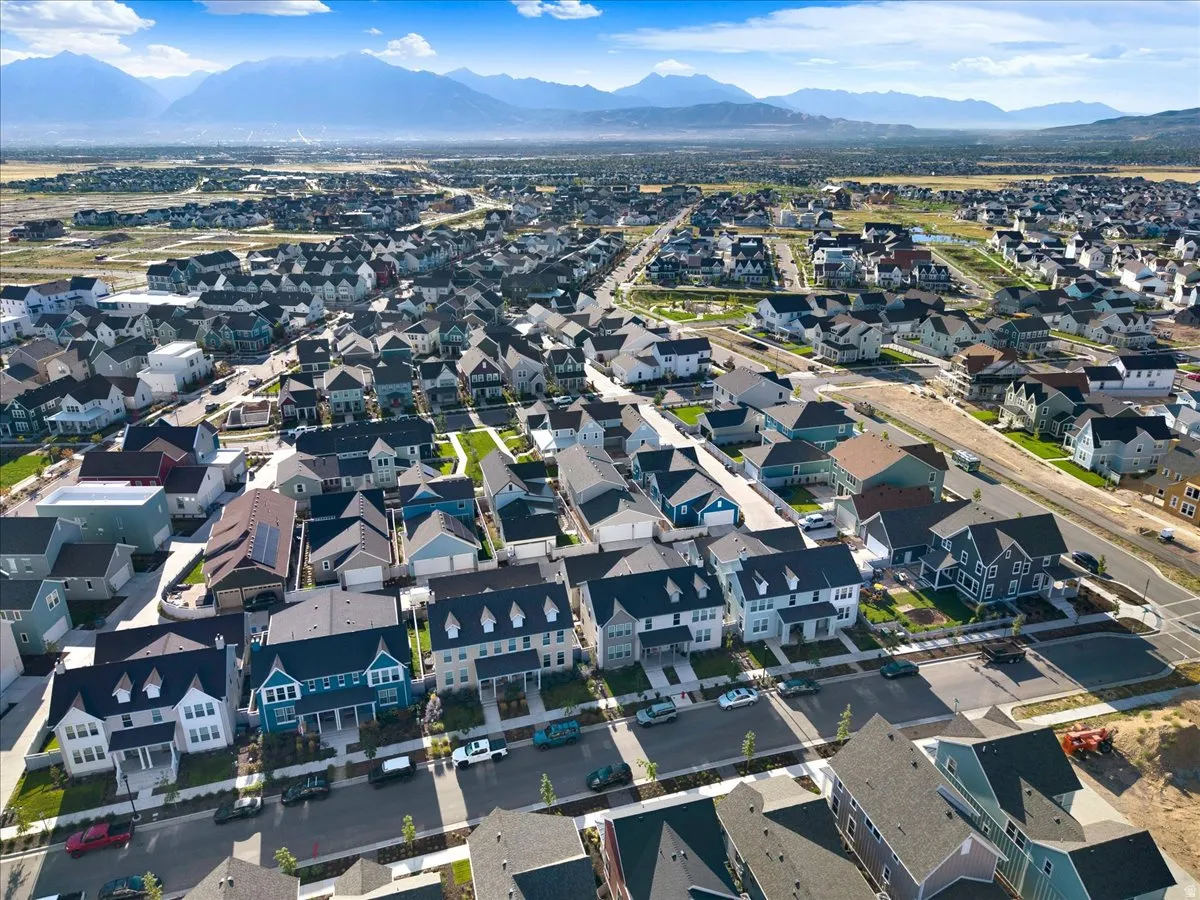 Expansive residential development with diverse architectural styles, mountain backdrop, and established streets
