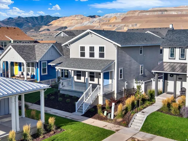 Contemporary exterior with light gray siding, white trim, and a covered porch