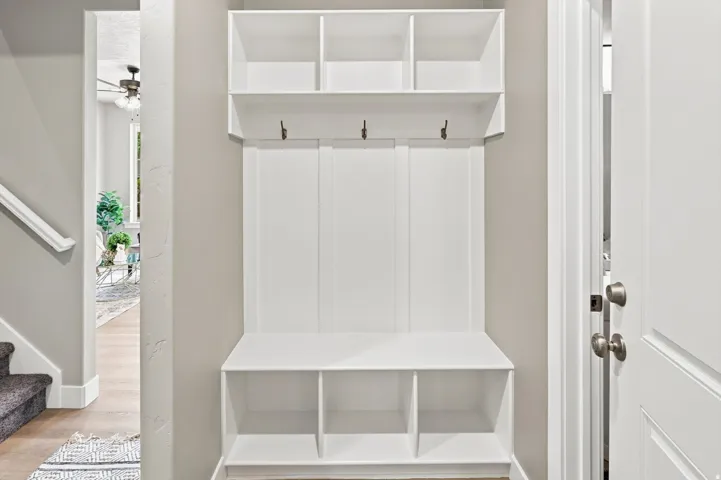 Built-in storage bench with upper shelving and coat hooks