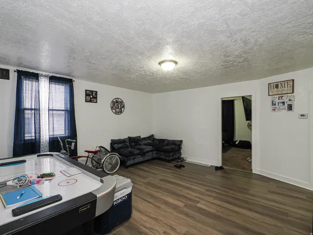Recessed lighting illuminates wood-finish flooring