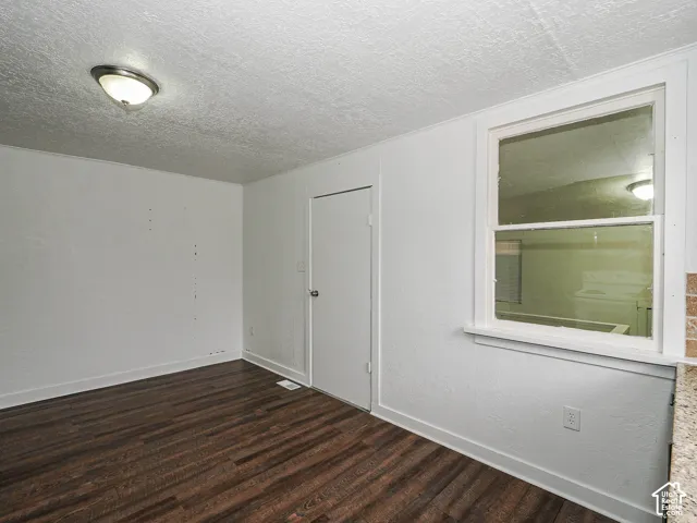 Interior space featuring wood-finish flooring, a single-hung window, and a dome-style ceiling light fixture