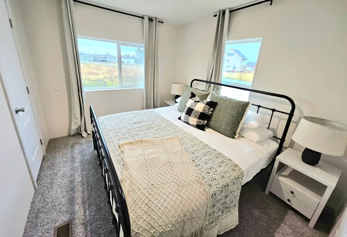 Neutral-toned walls complement the gray carpeting