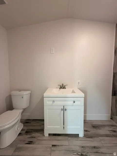 White vanity with cabinet storage, integrated sink, and brushed nickel faucet