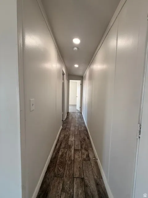 Hallway featuring recessed lighting and wood-finish flooring